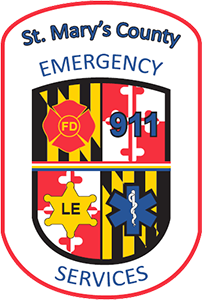 The Emergency Services logo - symbols for fire, 911, law enforcement, and ems services on top of a shield with the four quadrants of the Maryland flag. Reads 'St. Mary's County Emergency Services'.